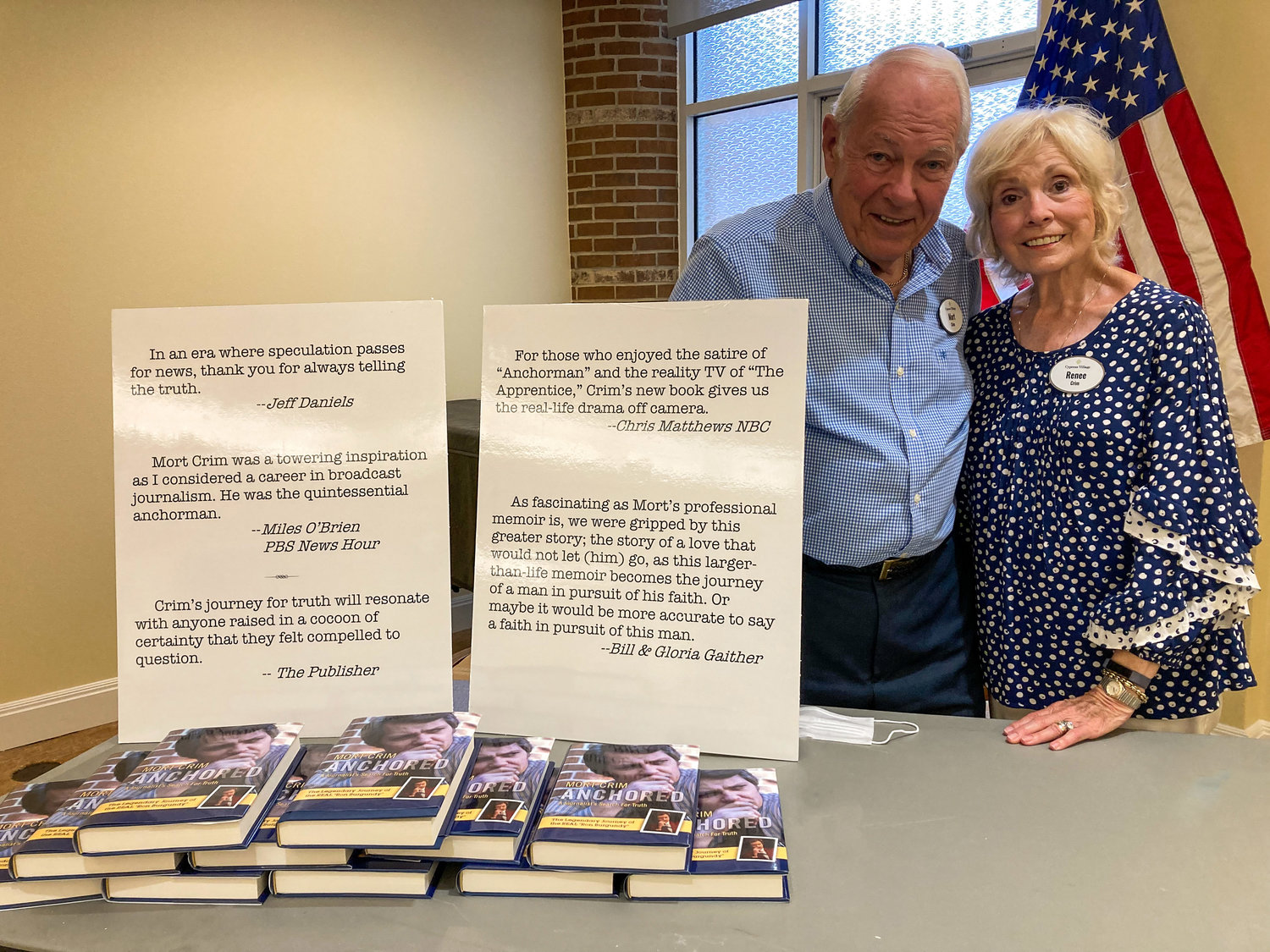Cypress Village residents Mort and Renee Crim pose with copies of Mort's new book, "Anchored: A Journalist's Search for the Truth."